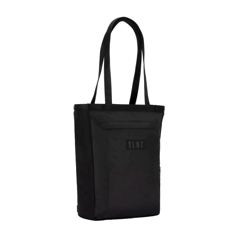 The SLNT E3 Faraday Tote Bag (17L) by SLNT is a black minimalist tote featuring two long handles, a front zippered pocket, and a small patch with "SLNT" on the front.