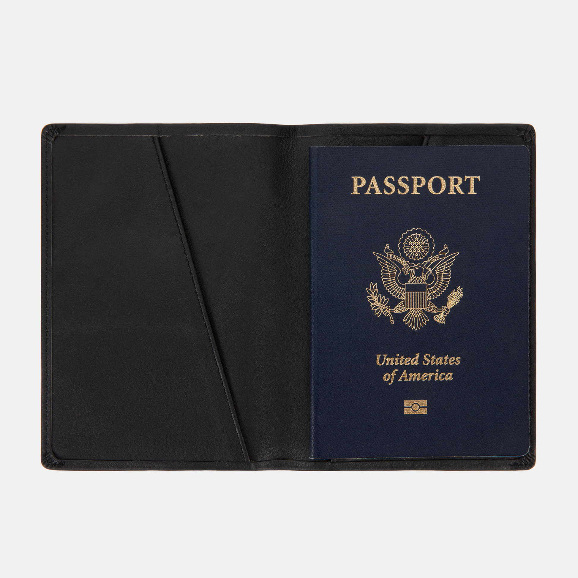 The SLNT RFID Passport Wallet by SLNT holds a U.S. passport with a navy blue cover, shown open against a white background.