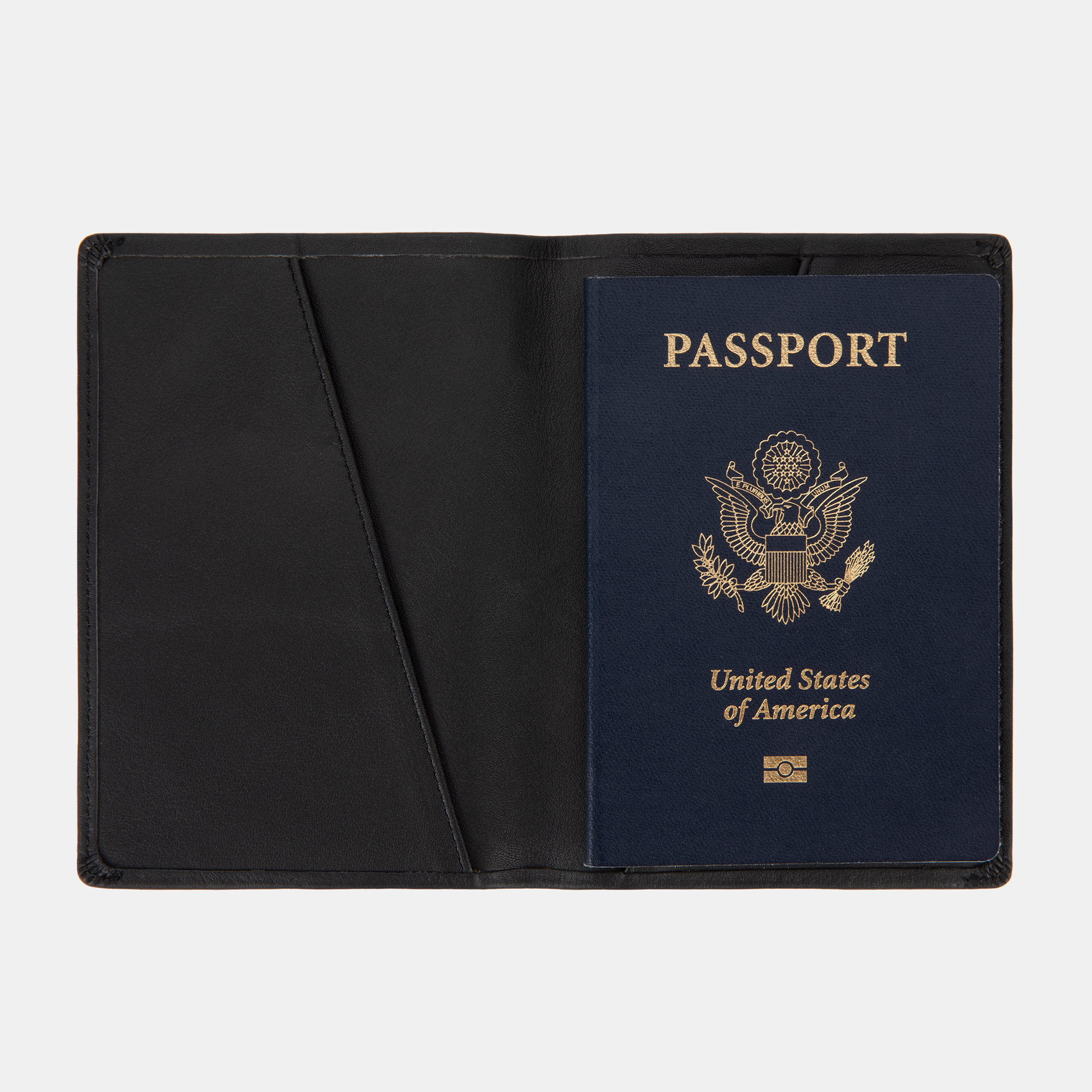The SLNT RFID Passport Wallet by SLNT holds a U.S. passport with a navy blue cover, shown open against a white background.