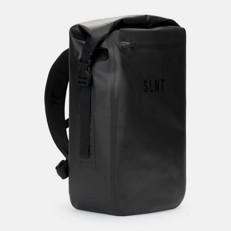 The SLNT Faraday Backpack Dry Bag (20L) is a sleek, black, waterproof backpack featuring a roll-top closure, adjustable padded shoulder straps, and minimalist modern design with the SLNT brand on the front.